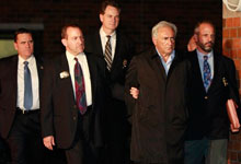 International Monetary Fund leader Dominique Strauss-Kahn is escorted away from the special victims unit precinct, Sunday, May 15, 2011 in New York. Strauss-Kahn is accused of sexually assaulting a maid in his hotel room in New York City. (Julio Cortez/AP)