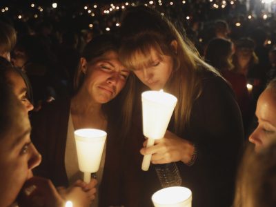 Kristen Sterner, left, and Carrissa Welding, both students of Umpqua Community College, embrace each other during a candle light vigil for those killed during a fatal shooting at the college, Thursday, Oct. 1, 2015, in Roseburg, Ore. (AP Photo/Rich Pedroncelli)