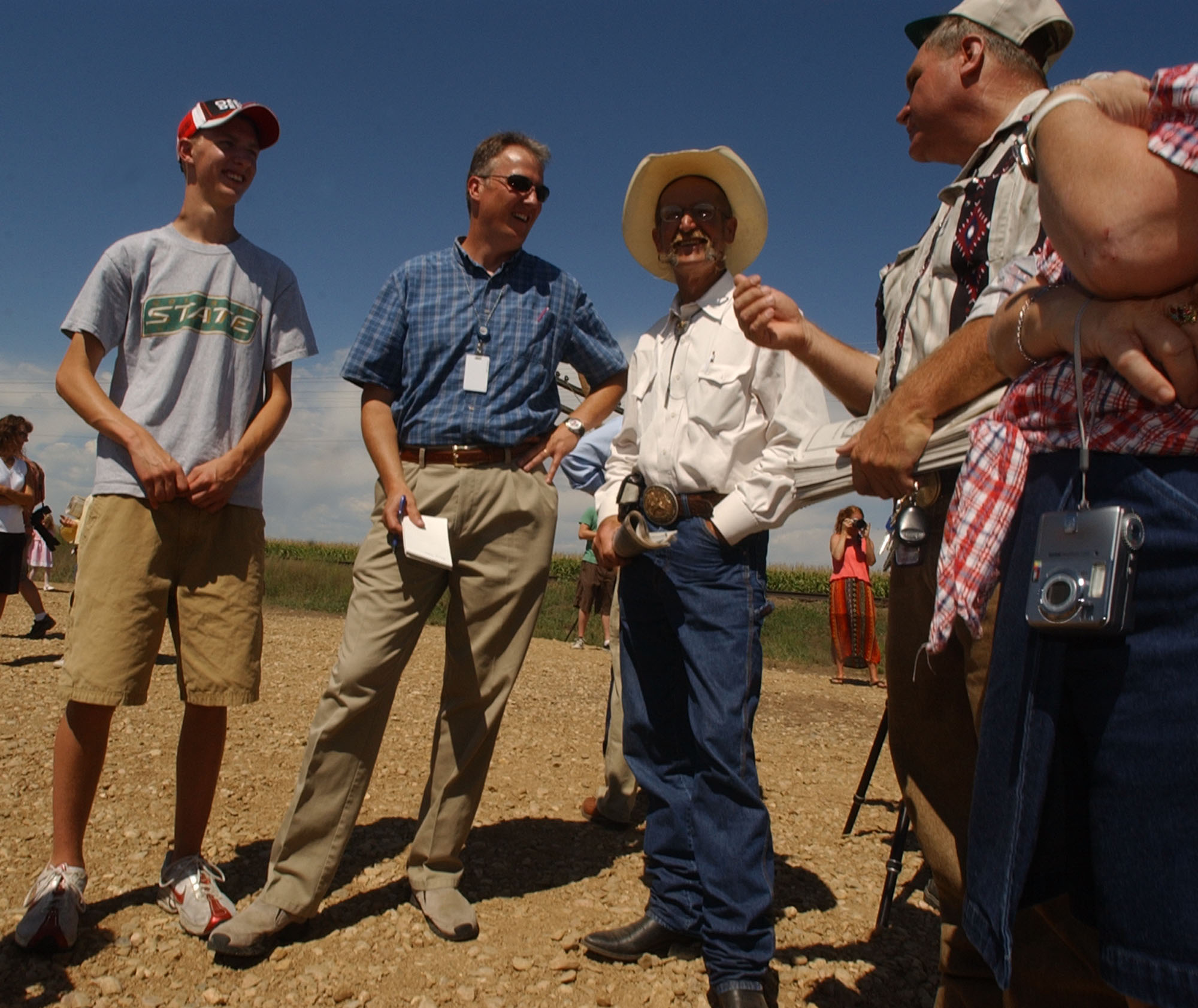 Kevin Vaughan stands between his son Forrest, far left, and Bruce Ford, a survivor of the crash. Frank Munson, who had two brothers and a sister on the bus, stands to the right. (Photo by  Rich Abrahamson) 