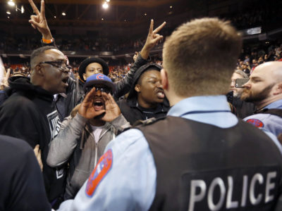 Protesters against Republican presidential candidate Donald Trump shout at Trump supporters after it was announced that the candidate's rally was canceled due to security concerns, on the campus of the University of Illinois-Chicago, Friday in Chicago. (AP Photo by Charles Rex Arbogast)