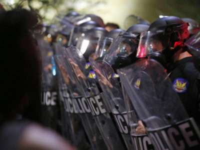 Police in riot gear block a street as hundreds of marchers take to the streets to protest against the recent fatal shootings of black men by police Friday, July 8, 2016, in Phoenix. (AP Photo by Ross D. Franklin)