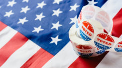 "I voted" sticker roll on American flag