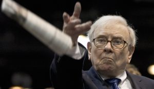 Warren Buffett tosses a newspaper during a newspaper tossing competition in Omaha, Neb., in 2012. (AP Photo/Nati Harnik)