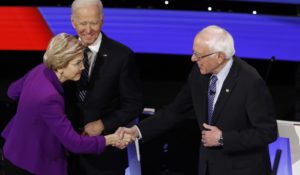 Democratic presidential candidates Elizabeth Warren, left, and Bernie Sanders, right, greet each other as Joe Biden, center, watches before Tuesday night’s Democratic presidential debate. (AP Photo/Patrick Semansky)