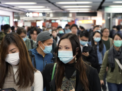 Passengers wear masks to prevent an outbreak of a new coronavirus in a subway station, in Hong Kong, Wednesday, Jan. 22, 2020. (AP Photo/Kin Cheung)