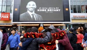 Fans of Kobe Bryant mourn in front of his image near Staples Center, home of the Los Angeles Lakers. (AP Photo/Matt Hartman)