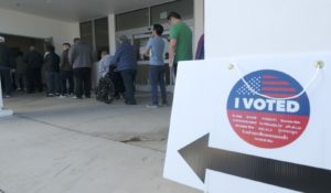 Voters wait in line to cast their ballot on Super Tuesday in California. (AP Photo/Ringo H.W. Chiu)
