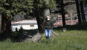 Don Angelo Riva walks in a park in Carenno, Italy, on April 2. Within two weeks of a lunch with his parents and an elderly priest, both his father and the priest were dead after contracting corona virus. His mother — a widow after 63 years of marriage — was nursing a fever quarantined in her valley home.  (AP Photo/Antonio Calanni)
