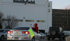 Employees and family members protest outside a Smithfield Foods processing plant in Sioux Falls, S.D. on April 9, 2020. The plant has had an outbreak of coronavirus cases according to Gov. Kristi Noem. (AP Photo/Stephen Groves File)