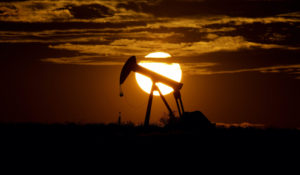 The sun sets behind an idle pump jack near Karnes City, Texas, Wednesday, April 8, 2020. Demand for oil continues to fall due to the COVID-19 outbreak. (AP Photo/Eric Gay)