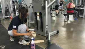 Sterling Henderson, 27, cleans gym equipment at Bodyplex Fitness Adventure on Friday, April 24, 2020, in Grayson, Georgia. (AP Photo/Sudhin Thanawala)