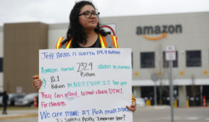 Breana Avelar, a processing assistant, holds a sign outside an Amazon fulfillment center in Romulus, Michigan, on April 1. Employees and family members are protesting in response what they say is the company's failure to protect the health of its employees in the pandemic. (AP Photo/Paul Sancya)