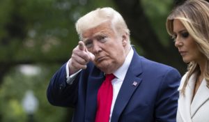 President Donald Trump, accompanied by first lady Melania Trump, points while walking as they return on Marine One on the South Lawn on Monday. (AP Photo/Alex Brandon)