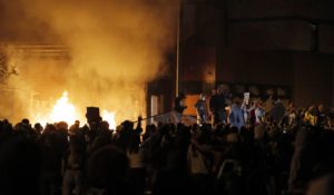 Protesters gather in front of the burning Minneapolis police 3rd Precinct building Thursday. Protests over the death of George Floyd, a black man who died in police custody, broke out in the city for a third straight night. (AP Photo/Julio Cortez)