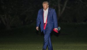 President Donald Trump walks on the South Lawn of the White House on Saturday night as he returns from a campaign rally in Tulsa, Okla. (AP Photo/Patrick Semansky)