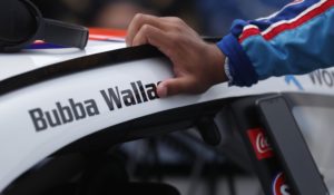 Driver Bubba Wallace leans on his car in the pits of the Talladega Superspeedway on Monday. (AP Photo/John Bazemore)