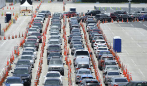 Cars wait in line at a coronavirus drive-up testing site set up at the Miami Beach Convention Center on July 10. (mpi04/MediaPunch /IPX)