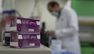Boxes of remdesivir, a medication used to treat the coronavirus, are seen as a lab technician works at the Eva Pharma facility in Cairo, Egypt, Sunday, July 12, 2020. (AP Photo/Nariman El-Mofty)