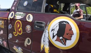 Rodney Johnson of Chesapeake, Virginia, stands with his truck outside FedEx Field in Landover, Maryland on Monday.  The Washington NFL franchise announced Monday that it will drop its nickname and Indian head logo immediately. (AP Photo/Susan Walsh)
