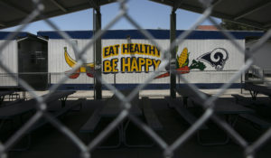 The cafeteria area of an elementary school is seen through a fence in Los Angeles, Friday, July 17, 2020. California Gov. Gavin Newsom laid out strict criteria Friday for school reopenings that makes it unlikely the vast majority of districts will have classroom instruction in the fall as the coronavirus pandemic surges. (AP Photo/Jae C. Hong)