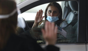 In this Friday, June 26, 2020 photo, U.S. District Judge Laurie Michelson, left, administers the Oath of Citizenship to Hala Baqtar during a drive-thru naturalization service in a parking structure at the U.S. Citizenship and Immigration Services headquarters on Detroit's east side.  (AP Photo/Carlos Osorio)