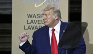 President Donald Trump pumps his fist after speaking during an event at the Whirlpool Corporation Manufacturing Plant in Clyde, Ohio on Monday (AP Photo/Tony Dejak)