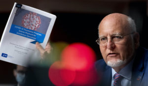 Centers for Disease Control and Prevention Director Dr. Robert Redfield holds up a “COVID-19 Vaccination Program Interim Playbook for Jurisdiction Operations” as he speaks at a Senate Appropriations subcommittee hearing Wednesday, Sept. 16, 2020, in Washington. (AP Photo/Andrew Harnik, Pool)