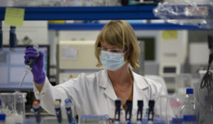 A lab technician works during research on a COVID-19 vaccine at a Johnson & Johnson subsidiary in Belgium, Wednesday, June 17, 2020. (AP Photo/Virginia Mayo)