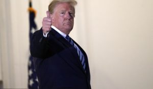President Donald Trump gestures as he returns to the White House on Monday after leaving Walter Reed National Military Medical Center. (AP Photo/Alex Brandon)