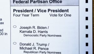 A portion of a Washington state mail-in ballot is shown with choices that include Donald Trump and Joe Biden for president. (AP Photo/Ted S. Warren)