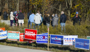 Voters wait in line to cast their ballots during early voting in Carmel, Ind, Friday, Oct. 30, 2020. Voters at this location waited approximately one hour to cast their vote. (AP Photo/Michael Conroy)