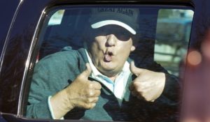 President Donald Trump gives two thumbs up to supporters as he departs after playing golf on Sunday. (AP Photo/Steve Helber)