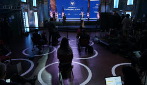 Reporters practice social distancing as President-elect Joe Biden, joined by Vice President-elect Kamala Harris, speaks at The Queen theater, Tuesday, Nov. 10, 2020, in Wilmington, Del. (AP Photo/Carolyn Kaster)