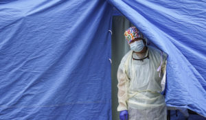 Medical workers operate a testing tent at a COVID-19 mobile testing site in Brooklyn. (AP Photo/John Minchillo)