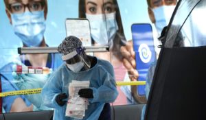 A health care worker works at a walk-up COVID-19 testing site on Wednesday in Miami. (AP Photo/Lynne Sladky)