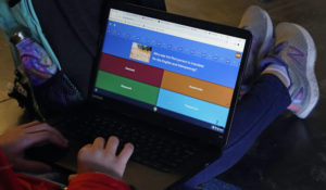 A sixth-grade student at Cape Cod Lighthouse Charter School works on her laptop, Thursday, Nov. 19, 2020, in East Harwich, Mass. (AP Photo/Elise Amendola)