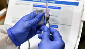 Registered Nurse Kath Olmstead prepares  a blinded study experimental vaccine for COVID-19 developed by the National Institutes of Health and Moderna Inc. at the United Health Services facility, Monday, July 27, 2020, in Binghamton, N.Y. (AP Photo/Hans Pennink