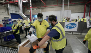 Boxes containing the Pfizer-BioNTech COVID-19 vaccine are prepared to be shipped at the Pfizer Global Supply Kalamazoo manufacturing plant in Portage, Mich., Sunday, Dec. 13, 2020. (AP Photo/Morry Gash, Pool)