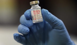 A vial of the Moderna COVID-19 vaccine is displayed at a pop-up vaccine clinic for EMS workers Center Tuesday, Jan. 5, 2021, in Salt Lake City. (AP Photo/Rick Bowmer)