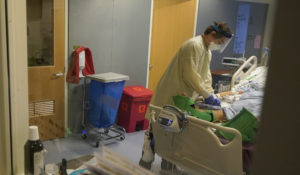 Clinical Nurse Zachary Petterson tends to a COVID-19 patient in the intensive care unit at Santa Clara Valley Medical Center during the coronavirus pandemic in San Jose, Calif., Wednesday, Jan. 13, 2021. (AP Photo/Jeff Chiu)