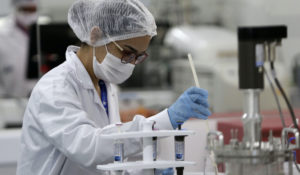 A laboratory employee works on the pilot production phase of Russia's Sputnik V vaccine for COVID-19 at the pharmaceutical company Uniao Quimica in Brasilia, Brazil, Monday, Jan. 25, 2021. (AP Photo/Eraldo Peres)