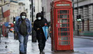 Pedestrians walk along Piccadilly in London, Friday, Jan. 29, 2021, during England's third national lockdown since the coronavirus outbreak began. (AP Photo/Kirsty Wigglesworth)