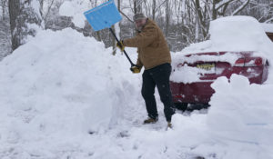 Bob McDonald shovels out his driveway and car in Mt. Arlington, N.J., Wednesday, Feb. 3, 2021. (AP Photo/Seth Wenig)