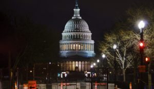 The Capitol is seen behind reinforced barricades as the second impeachment trial of former President Donald Trump begins in the Senate on Tuesday. (AP Photo/J. Scott Applewhite)