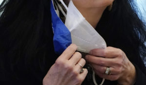 A state legislator adjusts her face masks while asking a question at the Capitol in Jackson, Miss. on Feb. 4. A government study released on Wednesday, Feb. 10, 2021, finds that wearing two masks can better than one, in protecting against coronavirus infection. (AP Photo/Rogelio V. Solis)