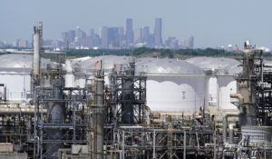 Storage tanks at a refinery along the Houston Ship Channel are seen with downtown Houston in the background, Thursday, April 30, 2020. (AP Photo/David J. Phillip)