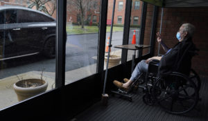 John O'Malley, right, visits with his son during a drive-by visit at The Hebrew Home at Riverdale in New York, Wednesday, Dec. 9, 2020. (AP Photo/Seth Wenig)