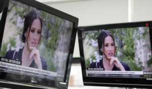 Australian televisions tune in to the interview of The Duke and Duchess of Sussex by Oprah Winfrey. (AP Photo/Rick Rycroft)
