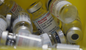 Empty vials of Moderna COVID-19 vaccine (AP Photo/Christophe Ena)