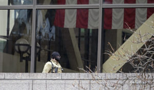 A National Guard soldier on an outside balcony at the Hennepin County Government Center, Wednesday, April 14 2021, in Minneapolis where testimony continues in the trial of former Minneapolis police officer Derek Chauvin continues. Chauvin is charged with murder in the death of George Floyd during an arrest last May in Minneapolis. (AP Photo/Jim Mone)